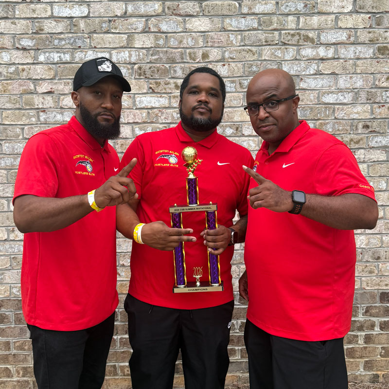 3 of the Hustlers Coaches holding a 2026 Trophy
